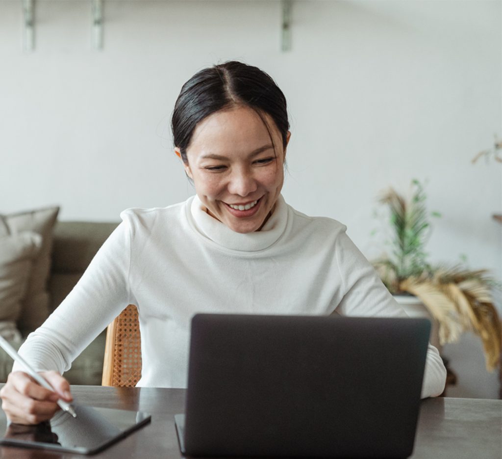 A person smiling at their computer