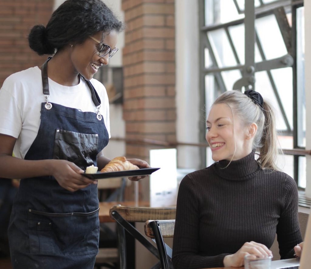 A waitress giving food to a customer