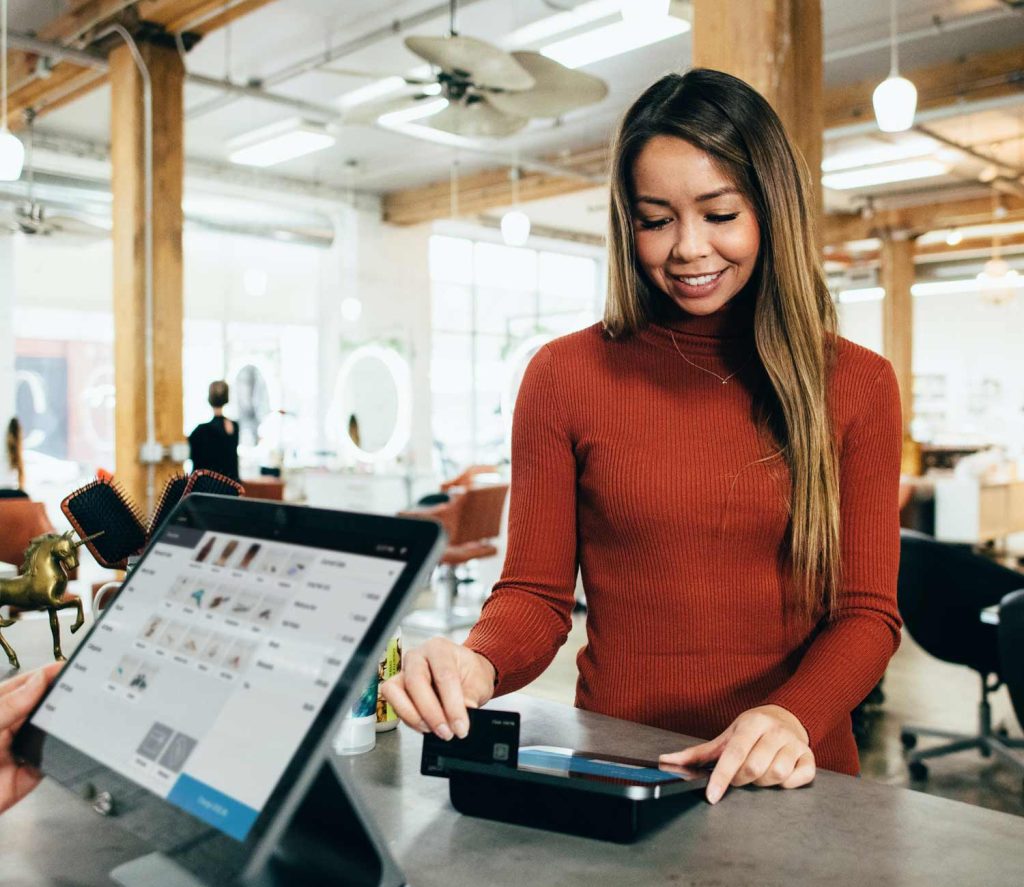 A person swiping their credit card at a store