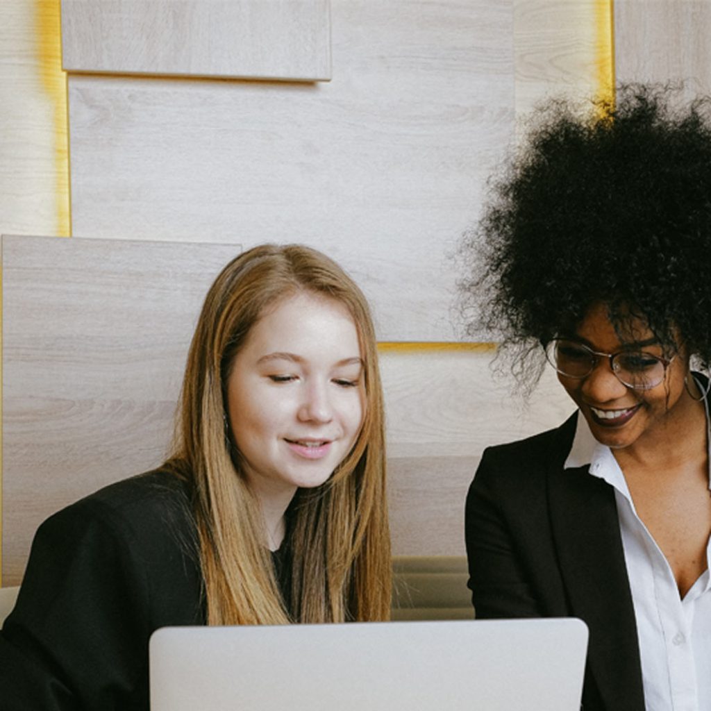 Two people working together on a laptop