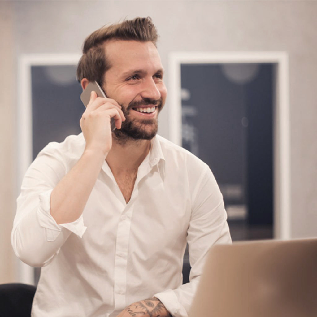 A person on the phone and smiling