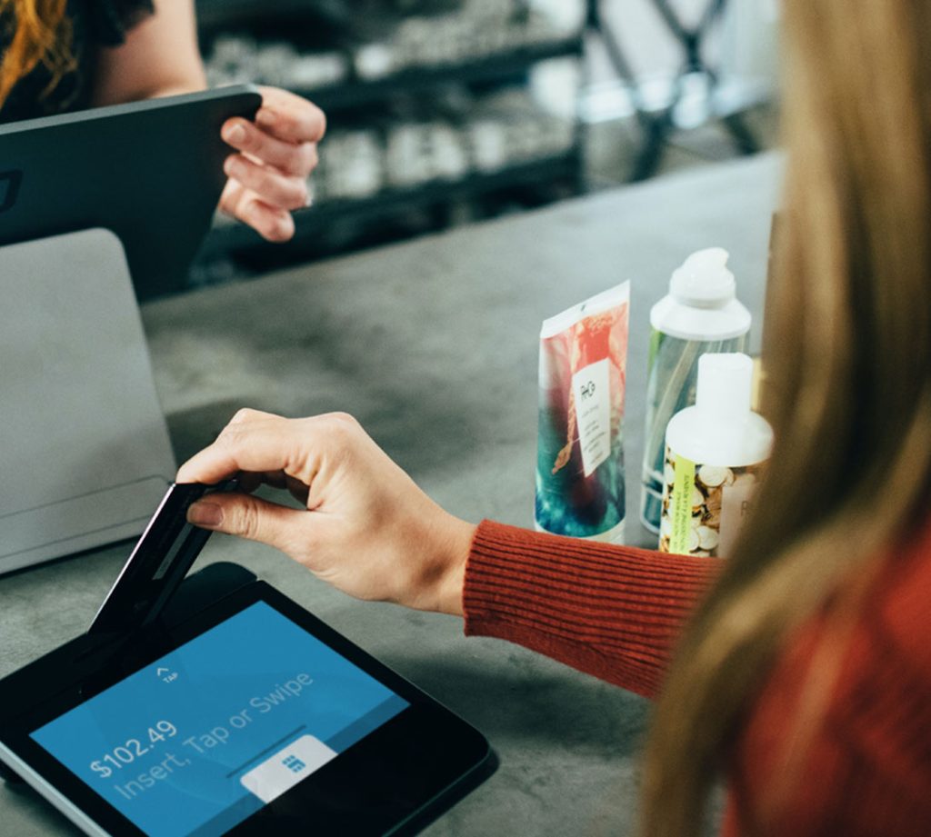 Someone using their credit card to make purchases at a store