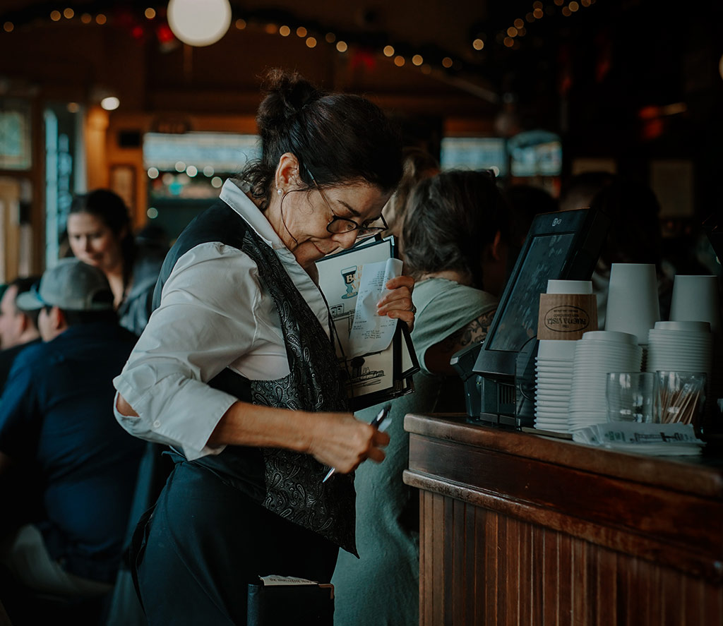 A waitress using a cash register