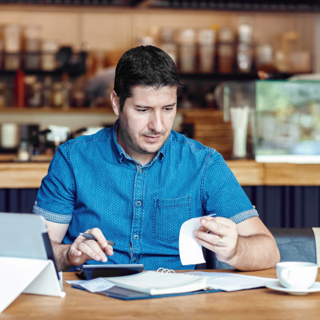 Restaurant Owner Manually Doing Finances