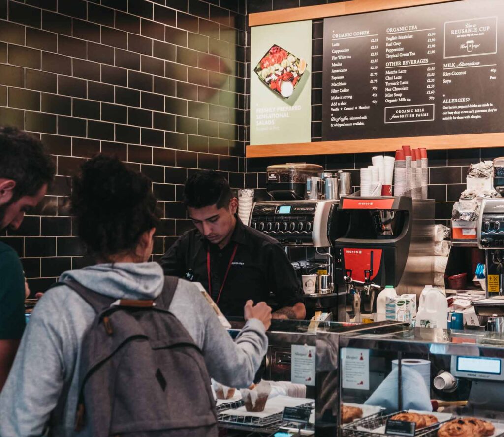 male female checkout at coffee shop