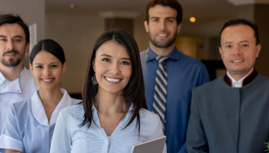 Group of Hospitality Professionals gathered together smiling for a picture.